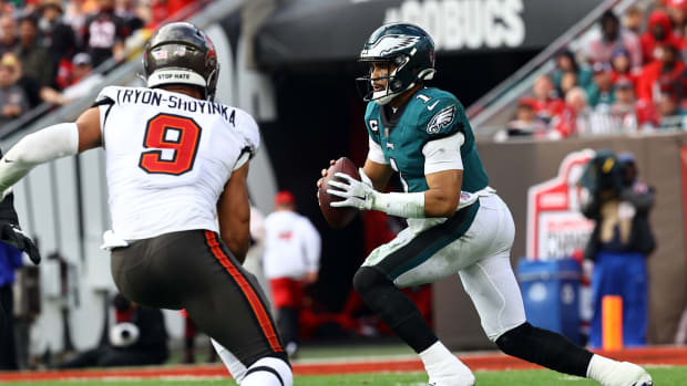 Jan 16, 2022; Tampa, Florida, USA;Philadelphia Eagles quarterback Jalen Hurts (1) drops back as Tampa Bay Buccaneers outside linebacker Joe Tryon-Shoyinka (9) defends during the second half in a NFC Wild Card playoff football game at Raymond James Stadium. Mandatory Credit: Kim Klement-USA TODAY Sports